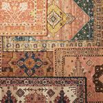 Overhead view of rug layered with other vintage-style rugs showing complementary color palettes