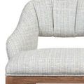 Close-up focusing on the upholstery texture and fabric weave pattern on curved armrest