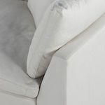 Detailed view of stitched seam on armrest next to a back cushion corner