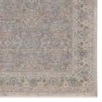 Detailed close-up of rug border highlighting blue and red floral motifs with intricate edging