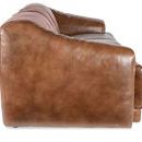 Side profile view highlighting continuous curved arm and the plush leather texture of sofa