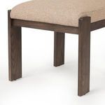 Close-up of front legs in solid ash wood with visible grain and beige seat upholstery