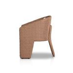 Side profile of wicker chair emphasizing the kickback detail on the rear leg