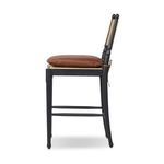 Side profile highlighting slim frame and tied leather cushion strap on back of Fayth Bar + Counter Stool