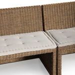Close-up detail of rattan weave and cushioned seating at joint between bench sections