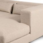 Close-up on armrest corner and one lumbar pillow illustrating fabric weave and stitching detail