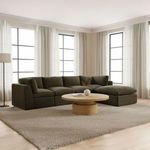 Large sectional sofa with Cates Slipper Chairs in bright room with white curtains and round wooden coffee table
