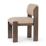 Angled side view of Hamlet Dining Chair highlighting thick seat cushion and wood grain on legs