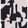 Abstract black and cream area rug with bold color block design and textured plush weave