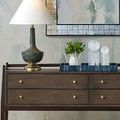 Smaller tray styled on wood sideboard with lamp and glass sculptures in room setting