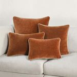 Multiple Harriet Velvet Throw Pillows in different sizes arranged on white sofa