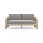 Front view showing clean architectural lines and wide armrests of the ash teak outdoor sofa with gray cushions