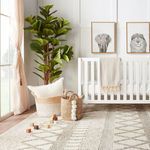 Woven detail of rug's repeating geometric design with soft natural fibers and wooden blocks