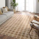 Japera rug styled in living room with gray sofa, wooden chair, and natural light through glass doors