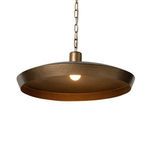 Eldon Pendant lit with warm light bulb illuminating hammered brass shade interior