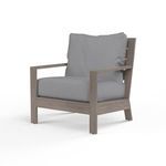 Outdoor Laguna Club Chair with hand-brushed driftwood aluminum frame and gray cushioned seat and back