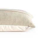 Side view of pillow showing zipper closure on plain beige back fabric