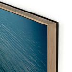 Close side angle showing smooth frame finish and print’s glossy surface reflecting light