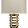 Labyrinth Table Lamp with rich antique brass metalwork in a hollow maze pattern and a beige fabric drum shade