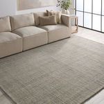 Natural light-filled living room setup with the rug under a beige sofa and side table accent