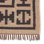 Macro close-up showing tight weave and detailed border pattern with knotted fringe ends