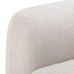 Side profile view showing plush armrest curve and fabric seam articulation