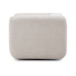 Opposite side profile showing thick armrest curve and subtle fabric weave