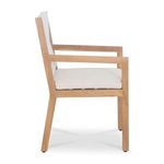 Side profile view emphasizing chair’s straight armrest and ivory cushion