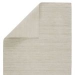 Rug corner flipped over highlighting the woven backing and underside texture