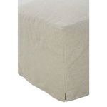 Rear view of slipcover ottoman showing straight skirt lines and low slit detail