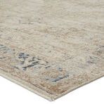 Close-up showing low pile texture and stitched edge of taupe and tan medallion rug