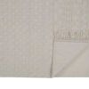 Back and side view of rug with corner folded, highlighting backing texture and fringed edge