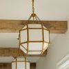 Morris Small Lantern shown hanging in hallway with wood ceiling beams and multiple lanterns in line