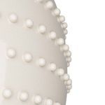 Extreme close-up focusing on bead texture and slight crackle detail in ceramic finish.