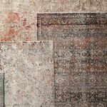 Comparison folded arrangement showing Elio Oriental Gray Black rug alongside a lighter contrasting rug