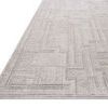 Close-up side angle of rug edge highlighting low pile height and detailed geometric pattern texture