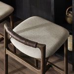 Top angle showing padded seat and leather-wrapped wooden backrest near island counter