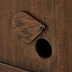 Hardware detail with matte black knobs contrasting wood grain of doors
