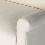 Detail of the rounded armrest seam and fabric weave on the chair