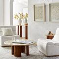 Darling Charcoal Rug styled in a bright living room with cream chairs, round wood coffee table, and textured walls