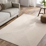 Cream geometric rug styled in living room with gray sofa, brown pillow, and wooden floor