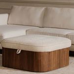 Closed Sonny ottoman in living room placed in front of white sofa on beige rug
