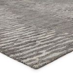 Close-up showing soft micro-tufted wool texture and edge binding of striped rug