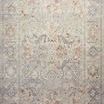 Interior shot of Rosemarie rug rolled at one end with visible low pile texture and bound edge on wooden floor