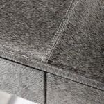 Detailed close-up of hair-on-hide texture and fine stitching around drawer edges