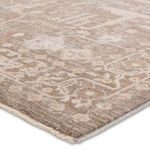 Close-up of the rug’s taupe and cream pile showing textured fibers and intricate pattern details