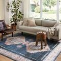 Heidi rug placed in living room under sofa and chair showing room context and styling