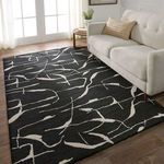 Rug placed in a sunny living room with light beige sofa and wooden floor, showing scale and styling.