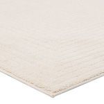 Close-up on corner showing plush high-low pile texture and cream color of Archias rug