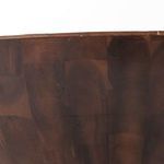 Close-up view of dark wood base with end-grain pattern and circular wood grain details